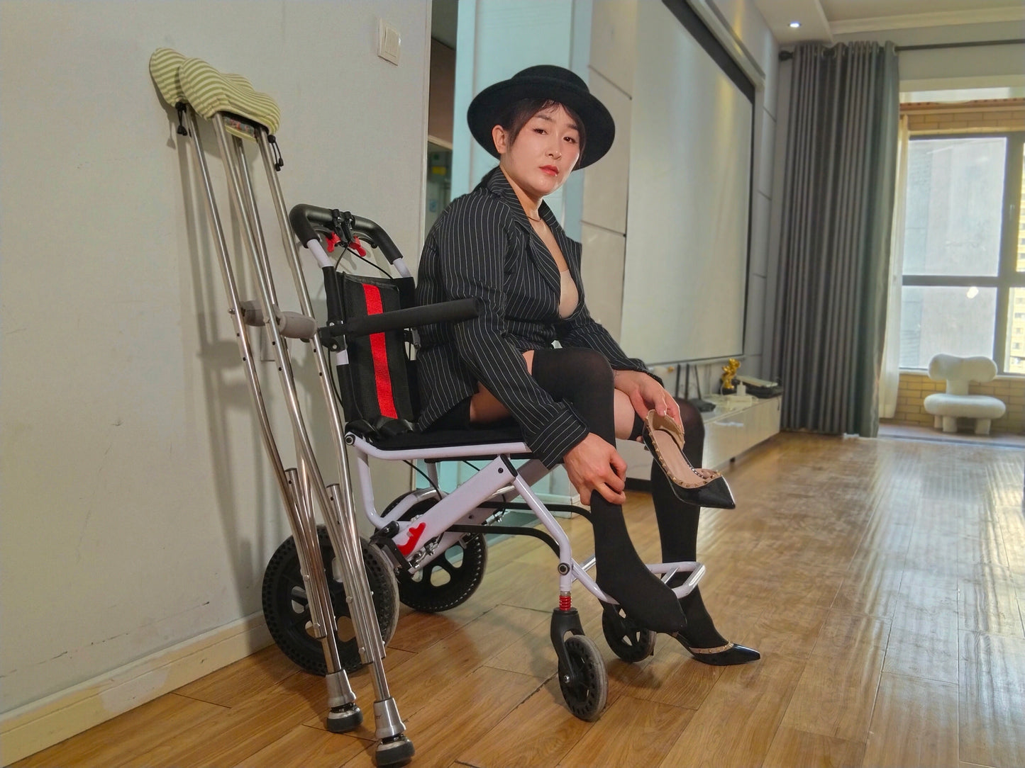 Rose the Polio Girl showcases over-the-knee socks on her legs of different thicknesses.