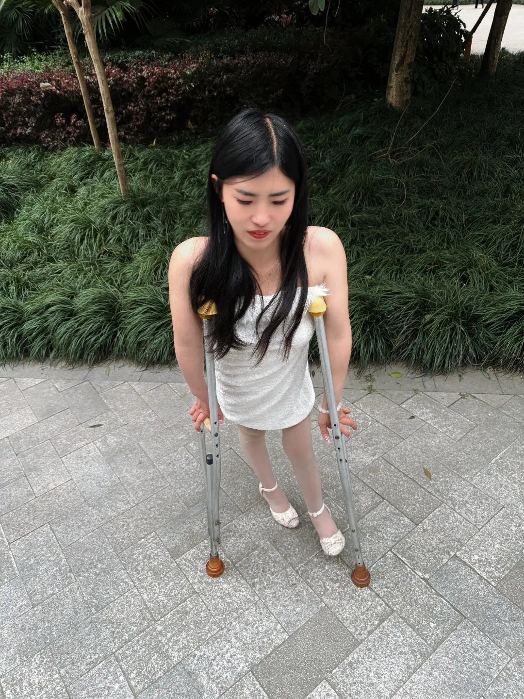 Maria: Polio Girl - Walking with crutches in a white chiffon dress AmputeeClub