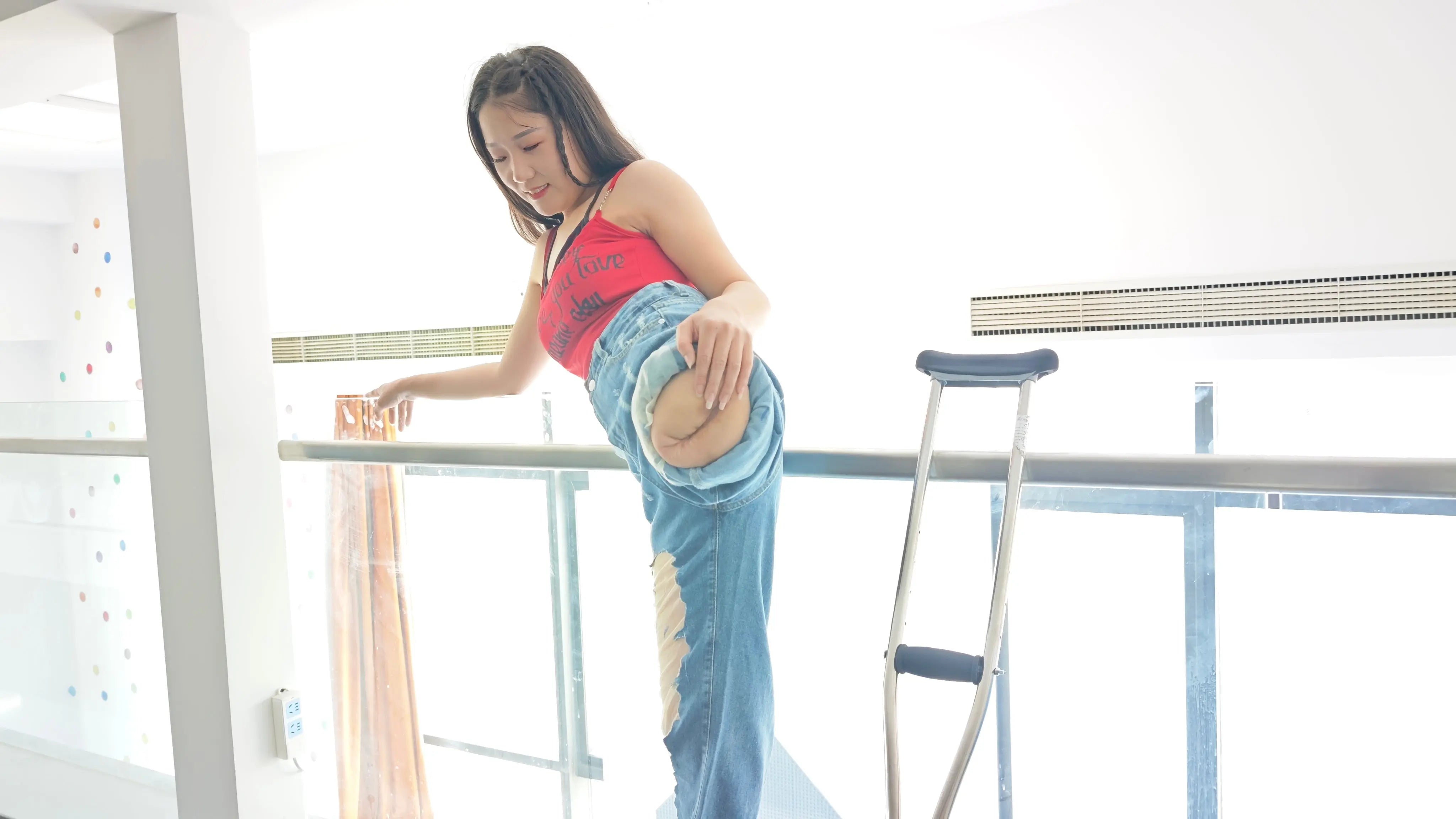 Naomi: Sak, an amputee girl, wearing blue jeans showing her stump