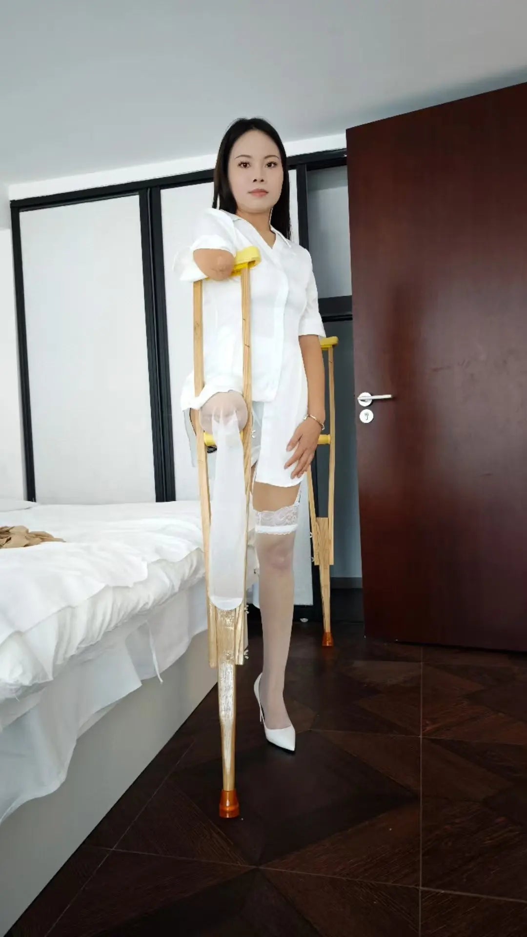 Abby: Ooe Amputee Girl - Wearing a white shirt and white high heels