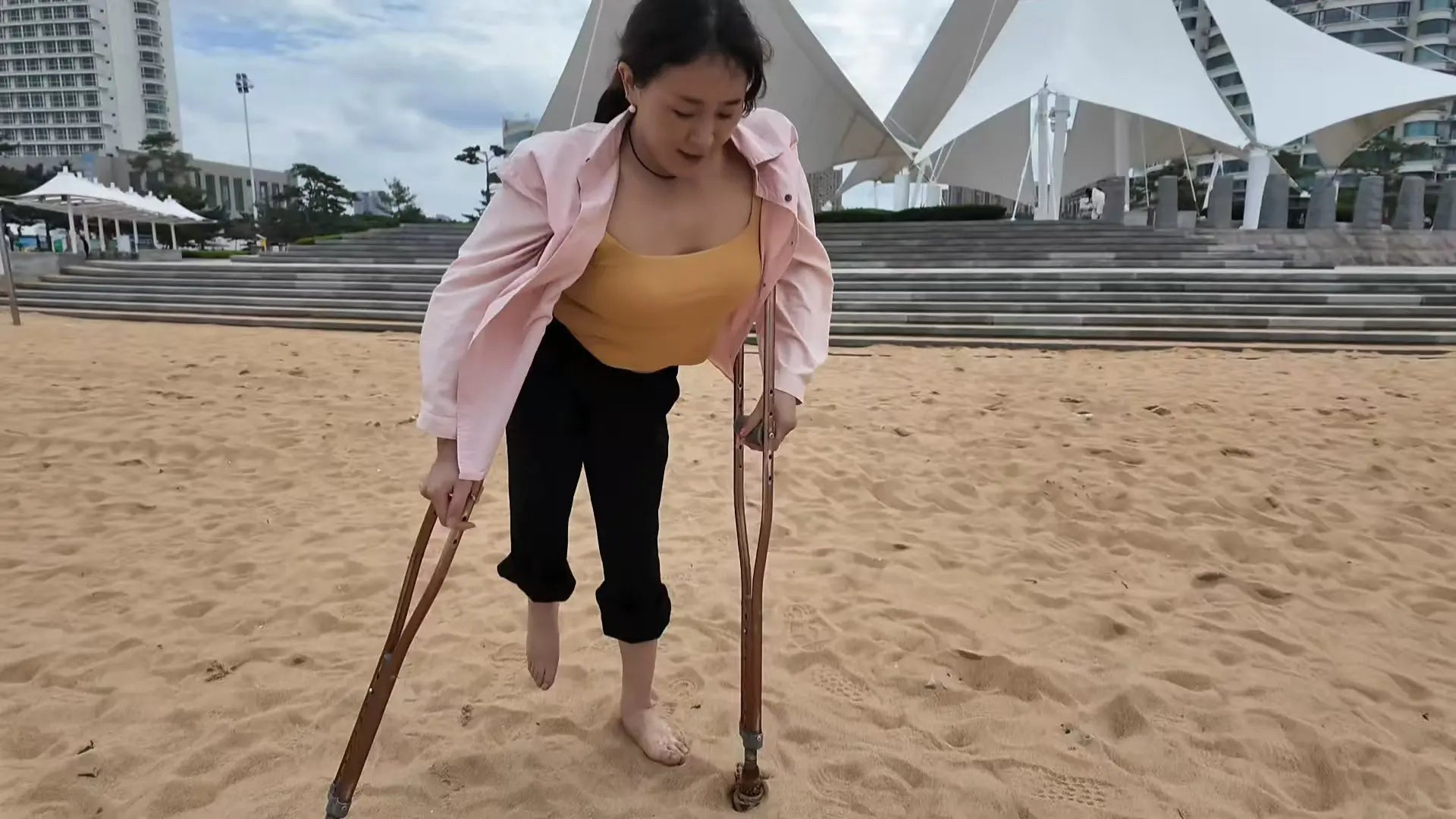 Rose The Polio Girl takes off her shoes and socks and plays on the beach AmputeeClub