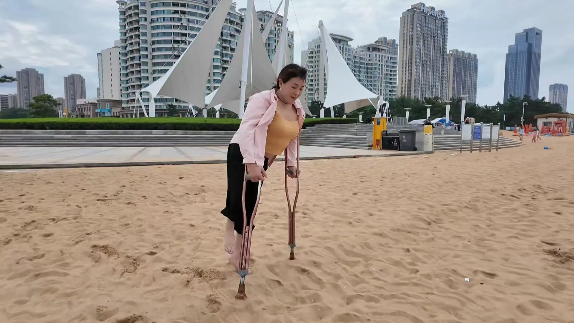 Rose The Polio Girl takes off her shoes and socks and plays on the beach AmputeeClub