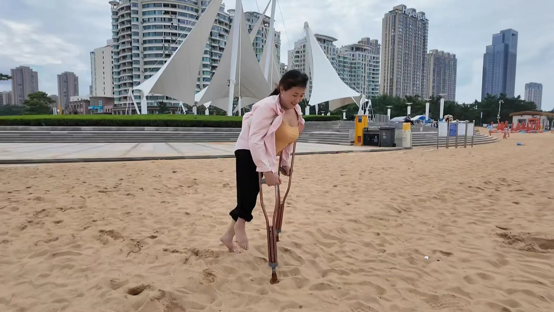 Rose The Polio Girl takes off her shoes and socks and plays on the beach AmputeeClub