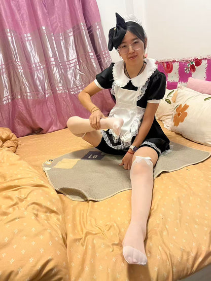 Zoe: Paraplegic Girl, a maid in white stockings, moves on a diaper pad.