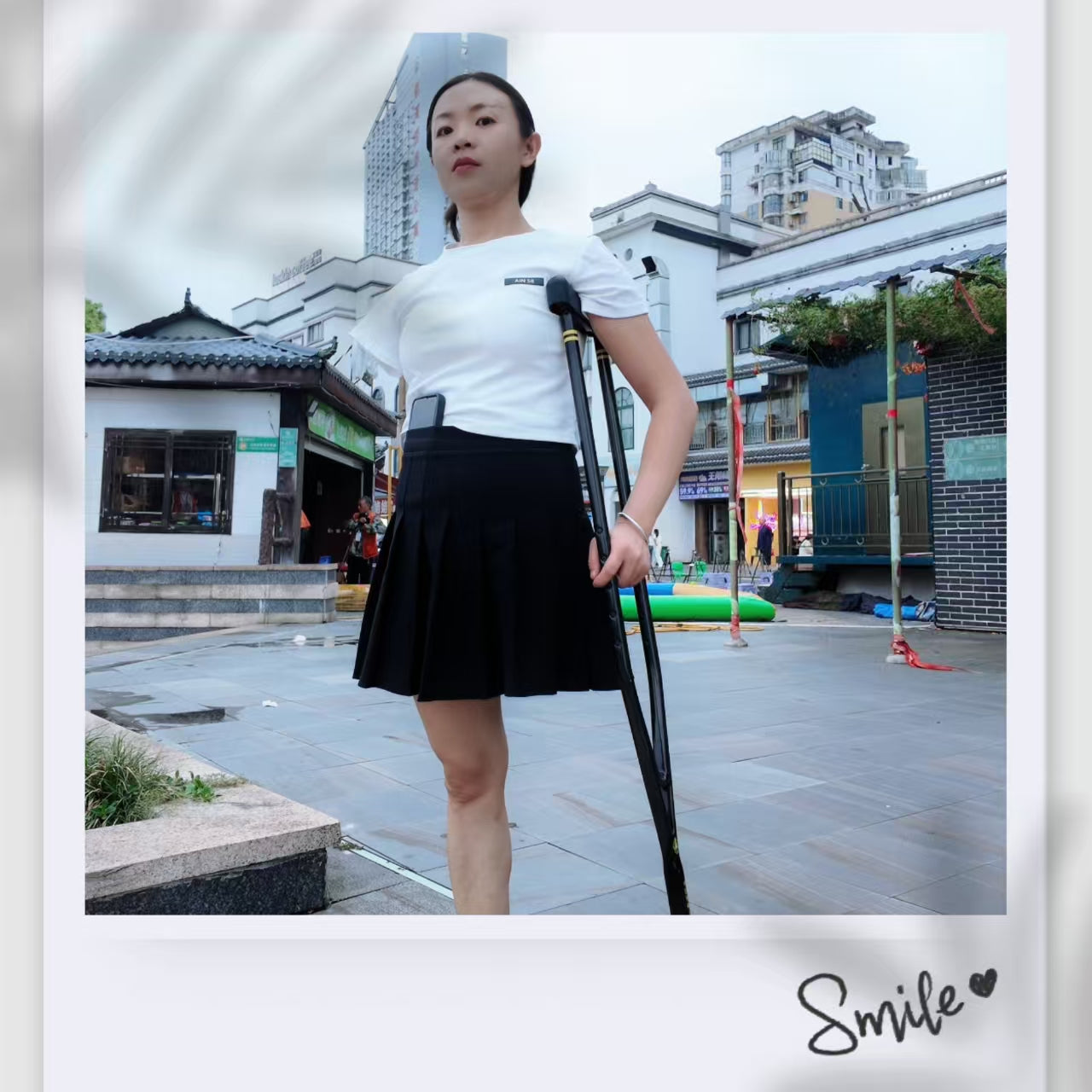 Mila: Ooe, the amputee girl, walking alone by the river with crutches.