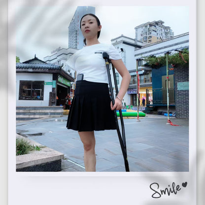 Mila: Ooe, the amputee girl, walking alone by the river with crutches.