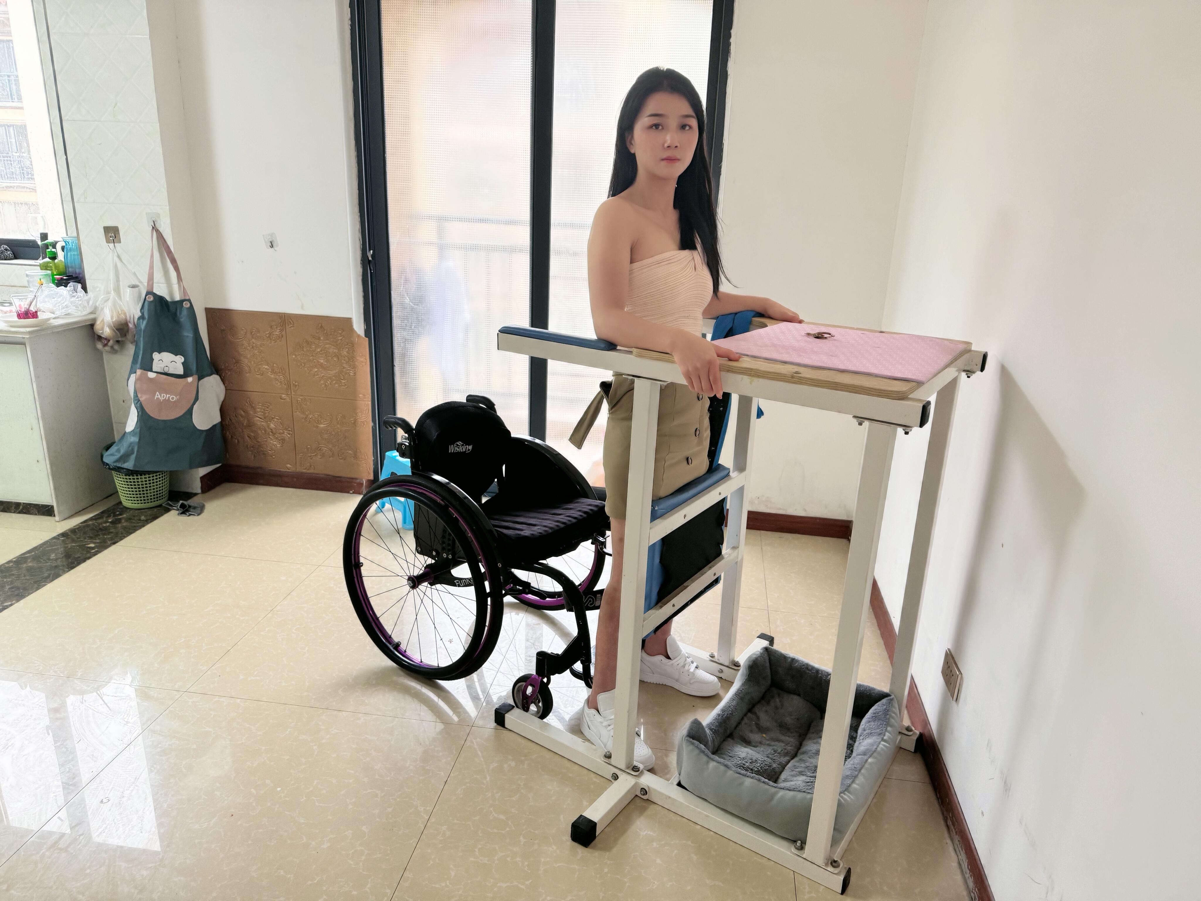 Belle: A paraplegic girl exercising with assistive devices