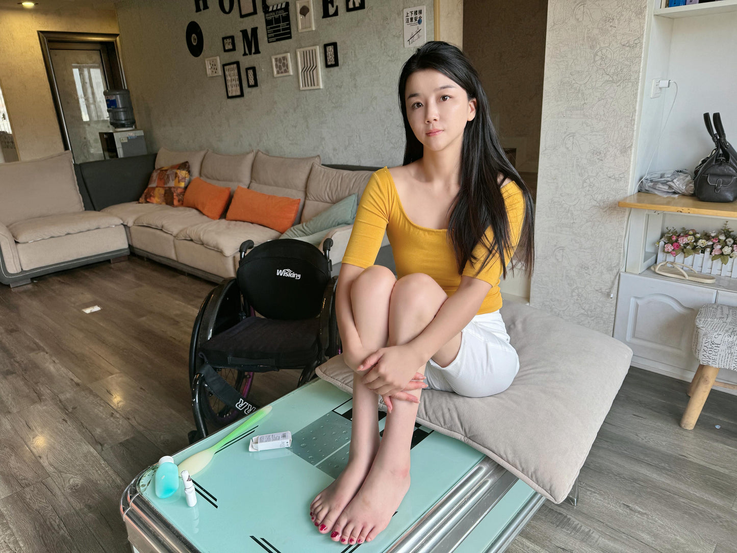 Belle: A paraplegic girl - washing her feet and applying nail polish