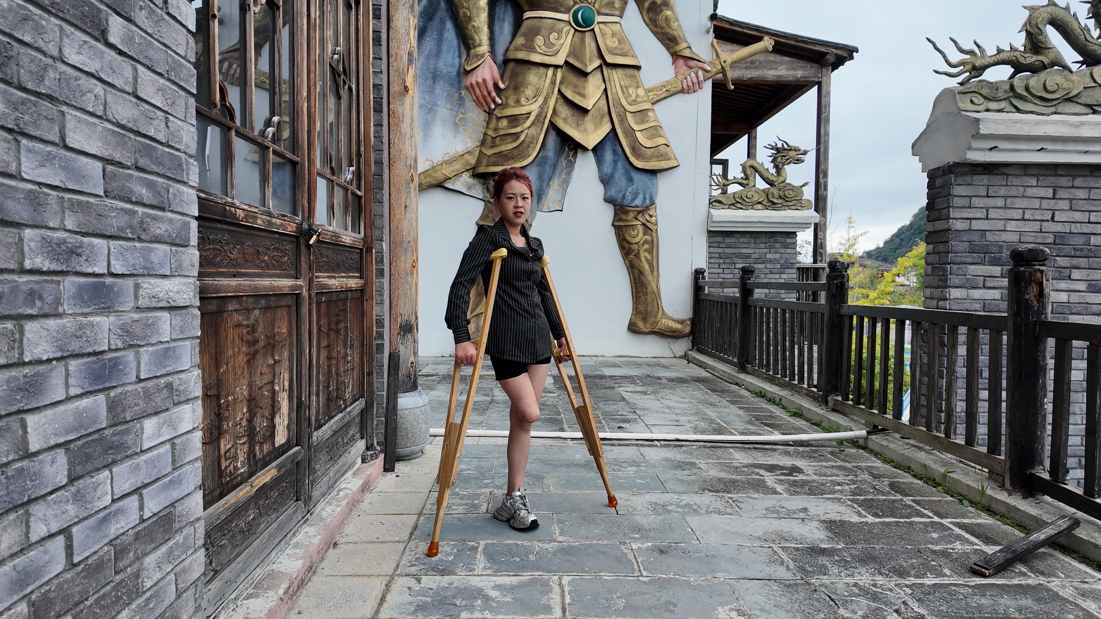 Amy: Sak Amputee girl, touring the ancient town on crutches.