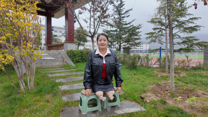 Tina, an amputee girl, strolls in the park in the rain.
