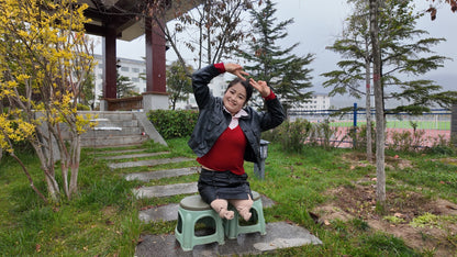 Tina, an amputee girl, strolls in the park in the rain.