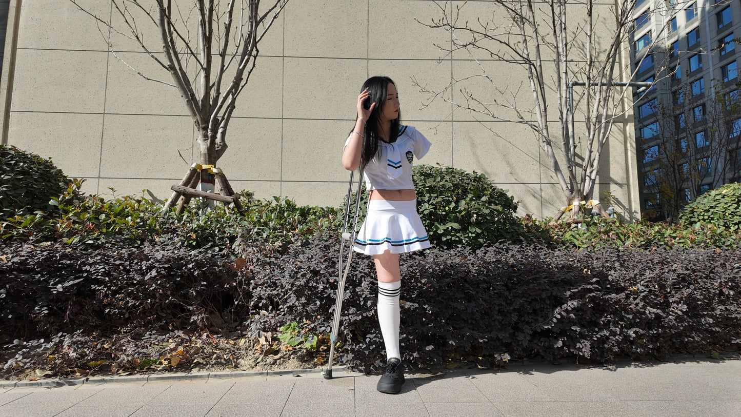 Beibei: OOE Amputee Girl, practicing walking with crutches while wearing a sailor uniform and a very short skirt.