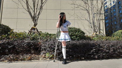 Beibei: OOE Amputee Girl, practicing walking with crutches while wearing a sailor uniform and a very short skirt.