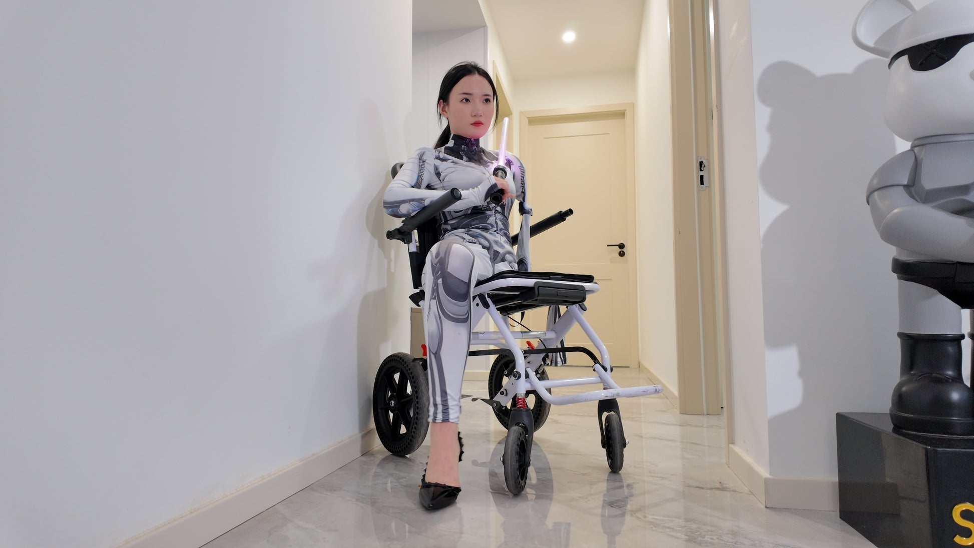 Beibei: OOE Amputee Girl cosplaying as a mechanical girl in an electric wheelchair.