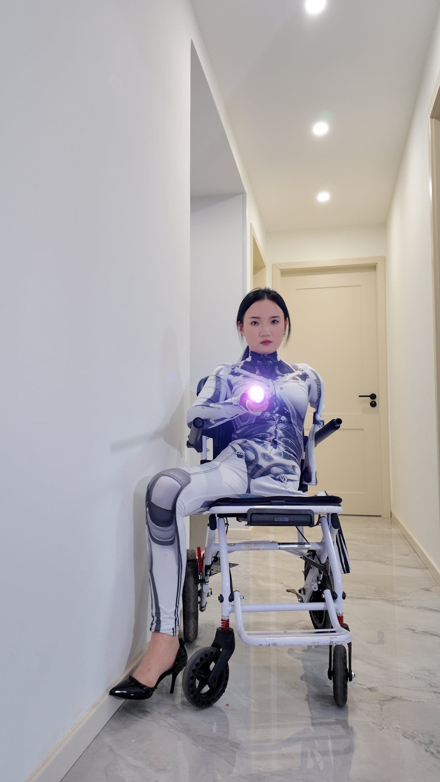 Beibei: OOE Amputee Girl cosplaying as a mechanical girl in an electric wheelchair.
