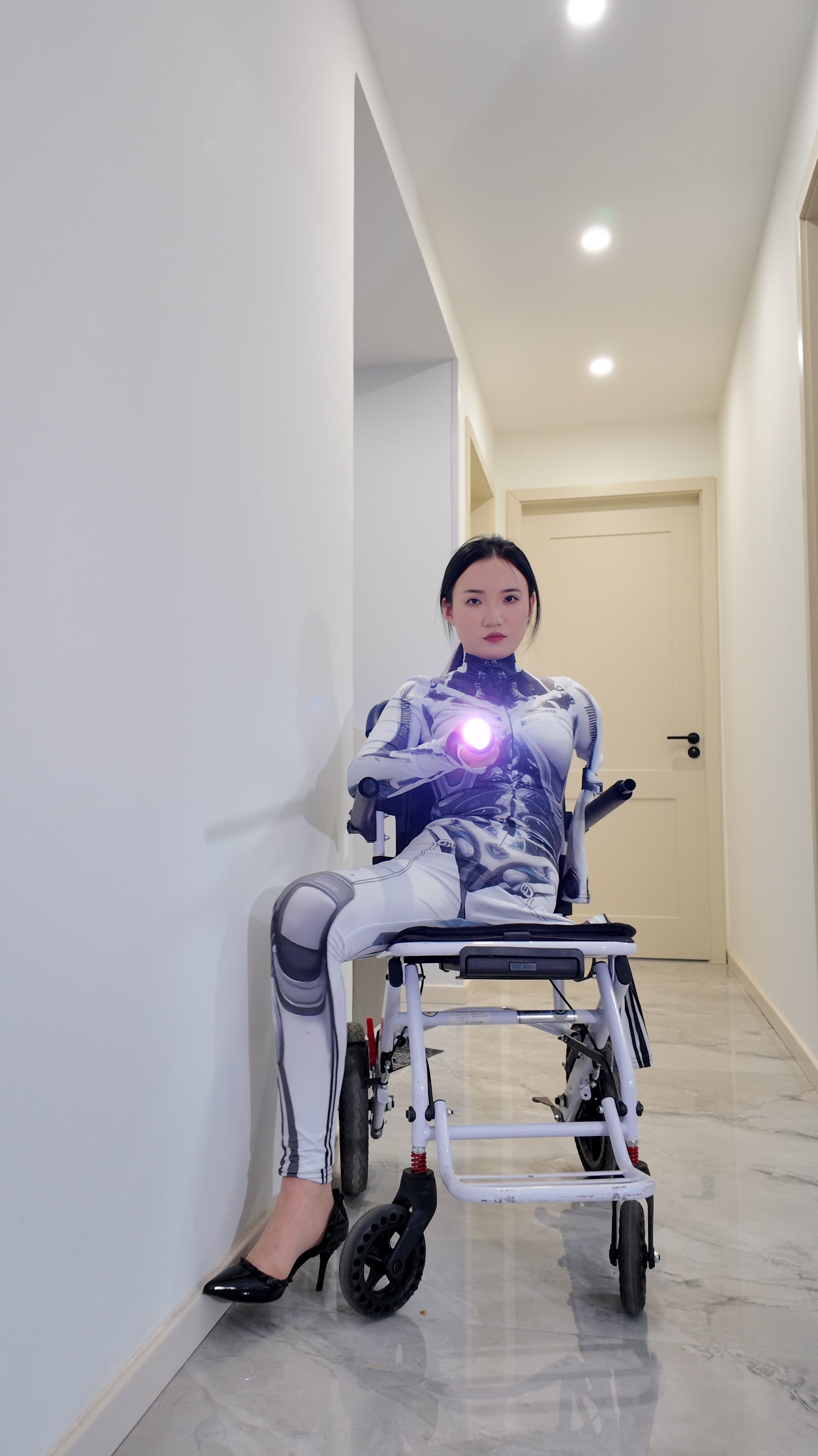 Beibei: OOE Amputee Girl cosplaying as a mechanical girl in an electric wheelchair.