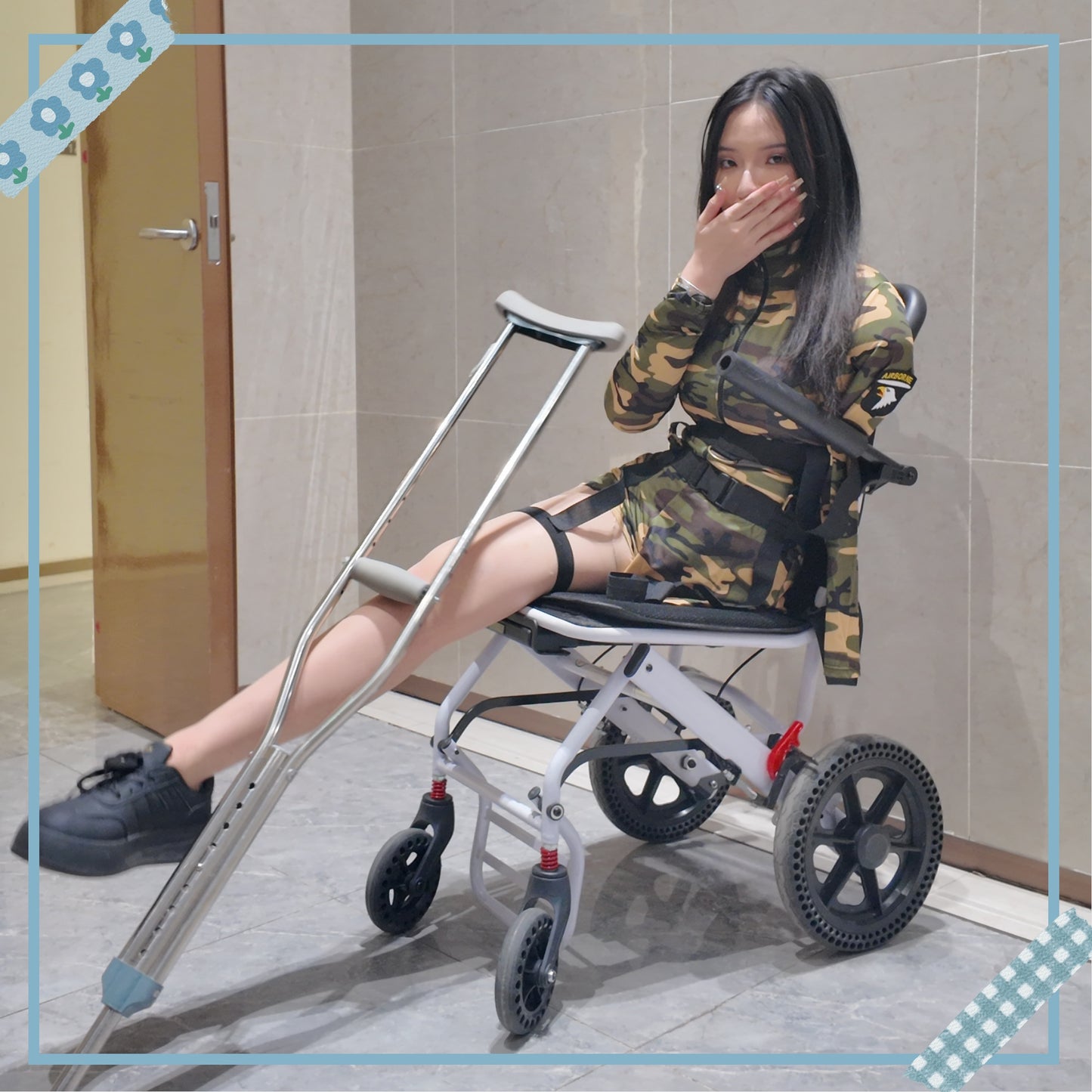 Beibei a Ooe Amputee Girl in camouflage outfit sitting in a wheelchair