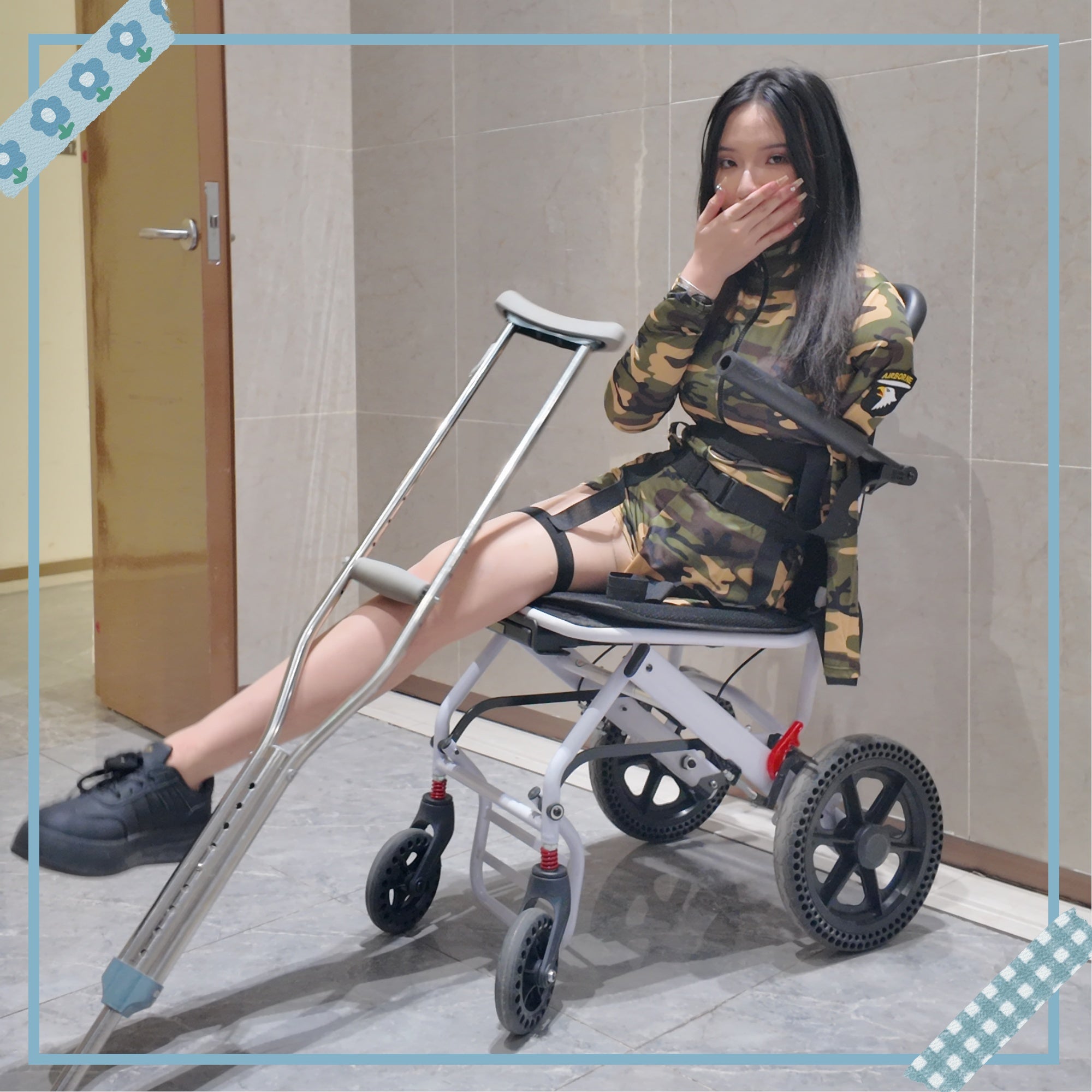 Beibei a Ooe Amputee Girl in camouflage outfit sitting in a wheelchair