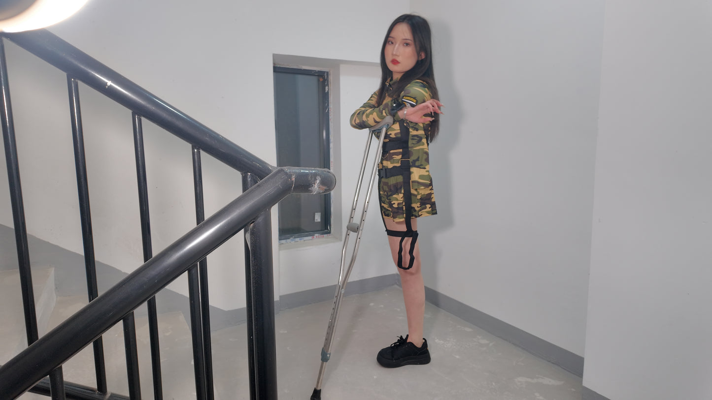 Beibei a Ooe Amputee Girl in camouflage outfit sitting in a wheelchair