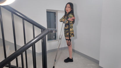 Beibei a Ooe Amputee Girl in camouflage outfit sitting in a wheelchair