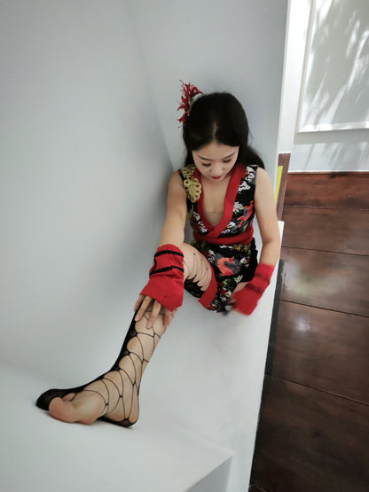 Naomi Sak, an amputee girl, plays with her prosthetic leg while wearing wooden clogs