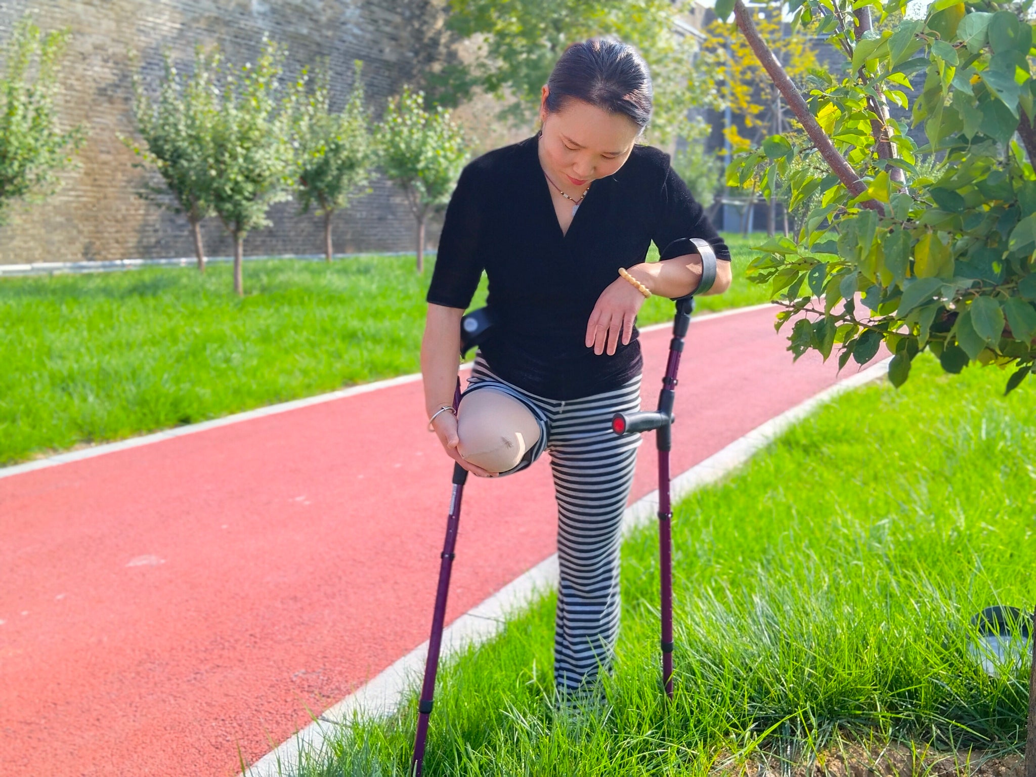 Gigi: Sak Amputee Girl - Using elbow crutches to go out for a walk in spring.
