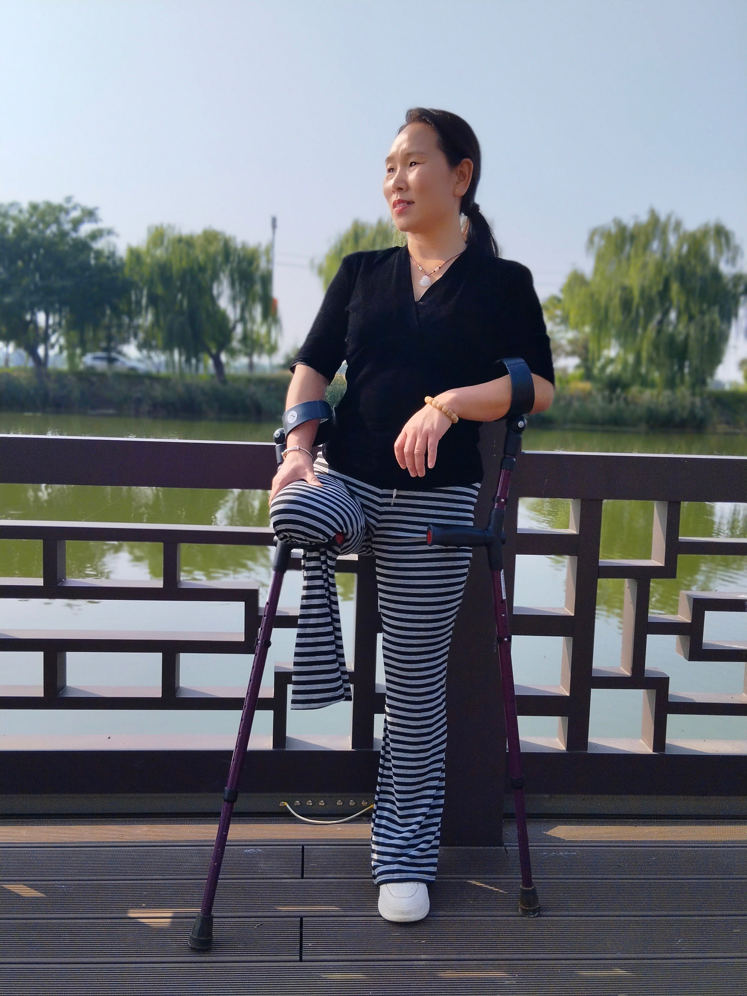 Gigi: Sak Amputee Girl - Using elbow crutches to go out for a walk in spring.