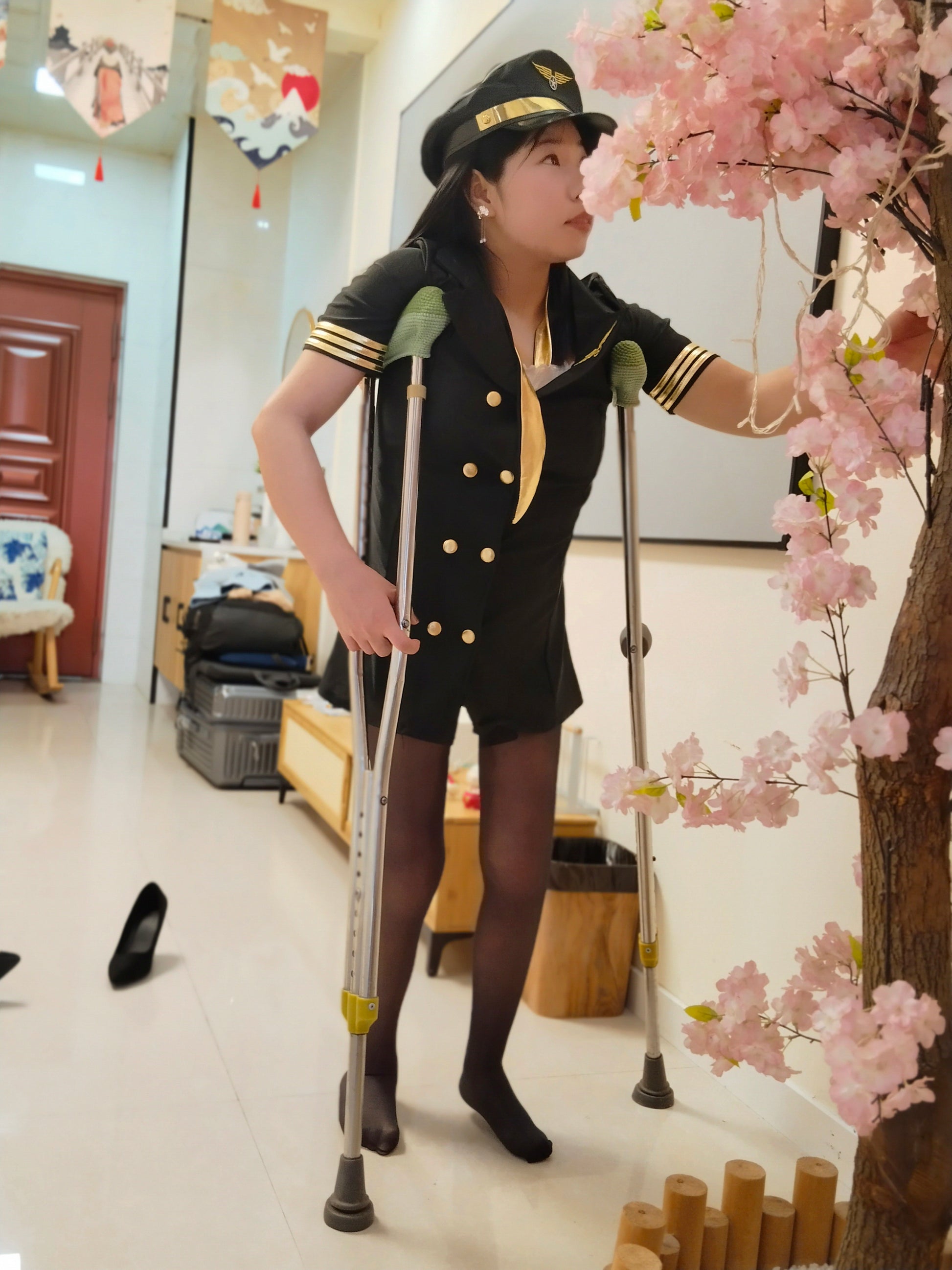 Twlia, a girl with polio, walks with crutches while wearing black stockings.