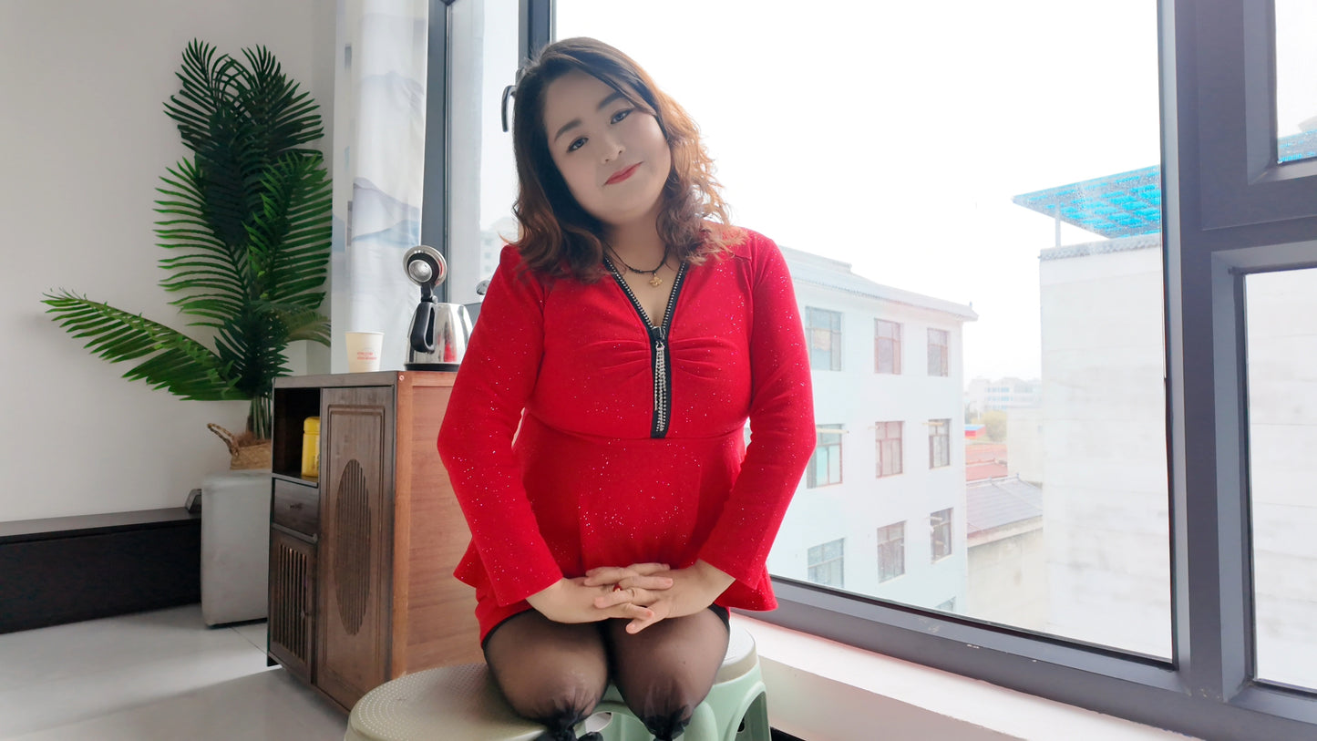 Tina, dressed in a red dress and wearing black, crawled on the bed.