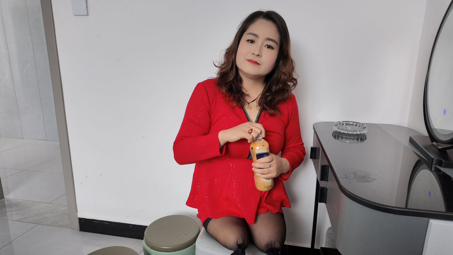 Tina, dressed in a red dress and wearing black, crawled on the bed.