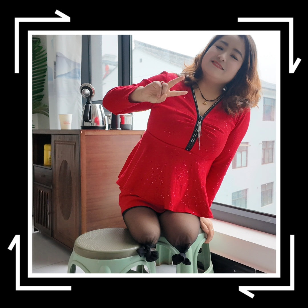 Tina, dressed in a red dress and wearing black, crawled on the bed.