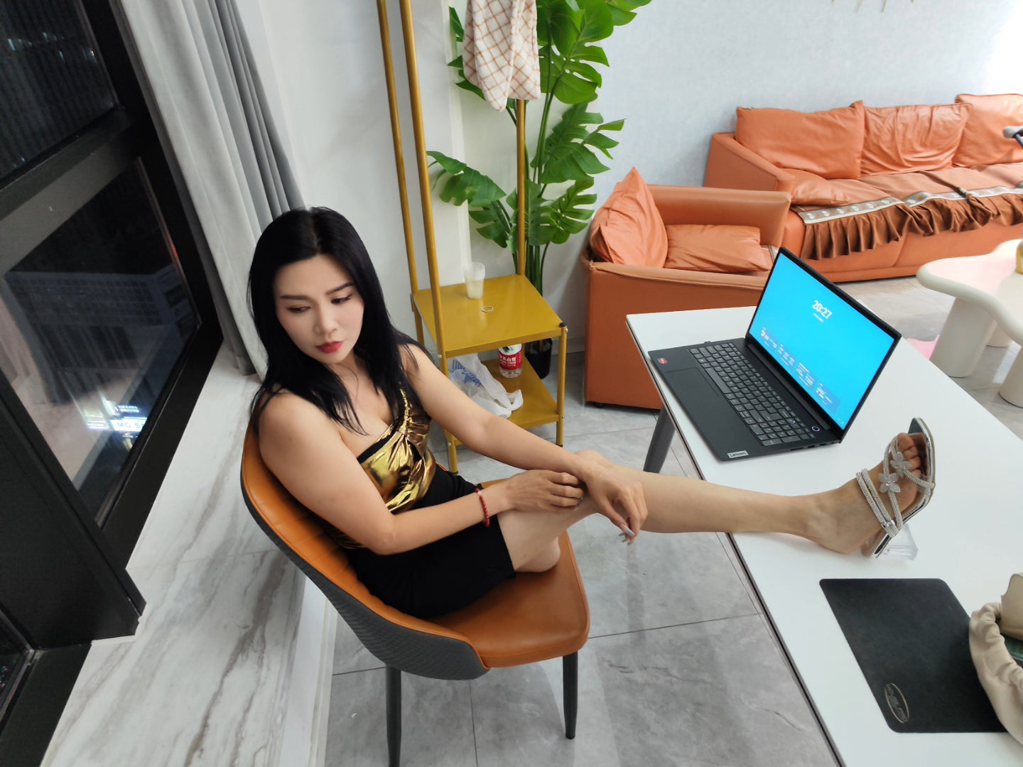 Rika Sak Amputee Girl: Gold strapless top with black mini skirt and stockings