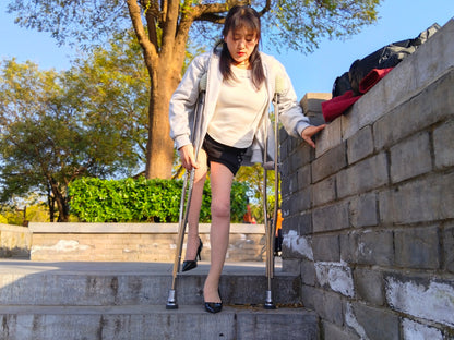 Rose, a girl with polio, climbed the stairs wearing high heels and using crutches.