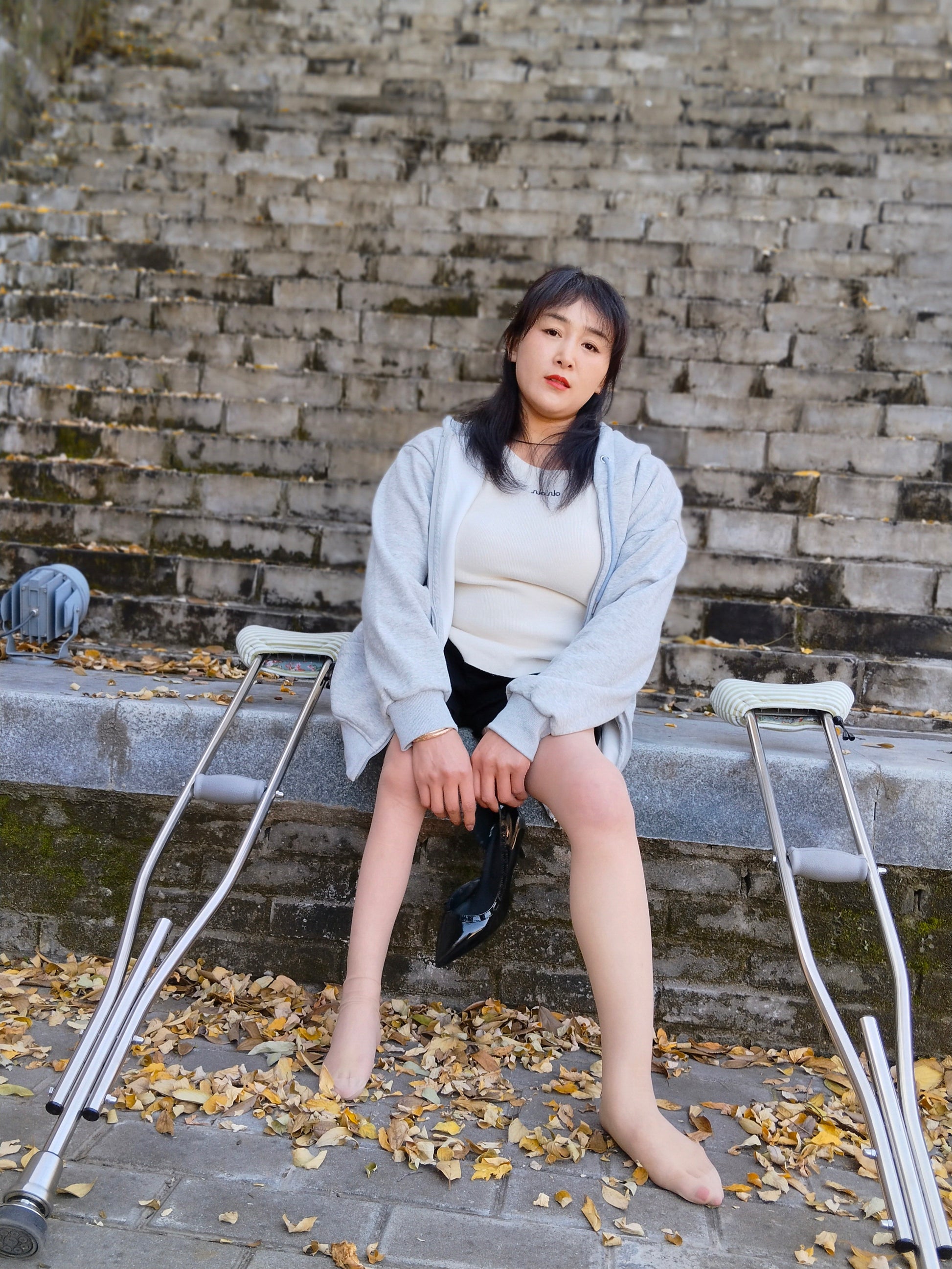 Rose, a girl with polio, climbed the stairs wearing high heels and using crutches.