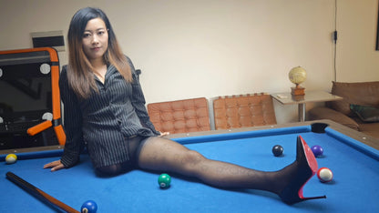 Emma: Shd Amputee Girl displays her beautiful legs in black stockings and her prosthetic limb on a billiard table.
