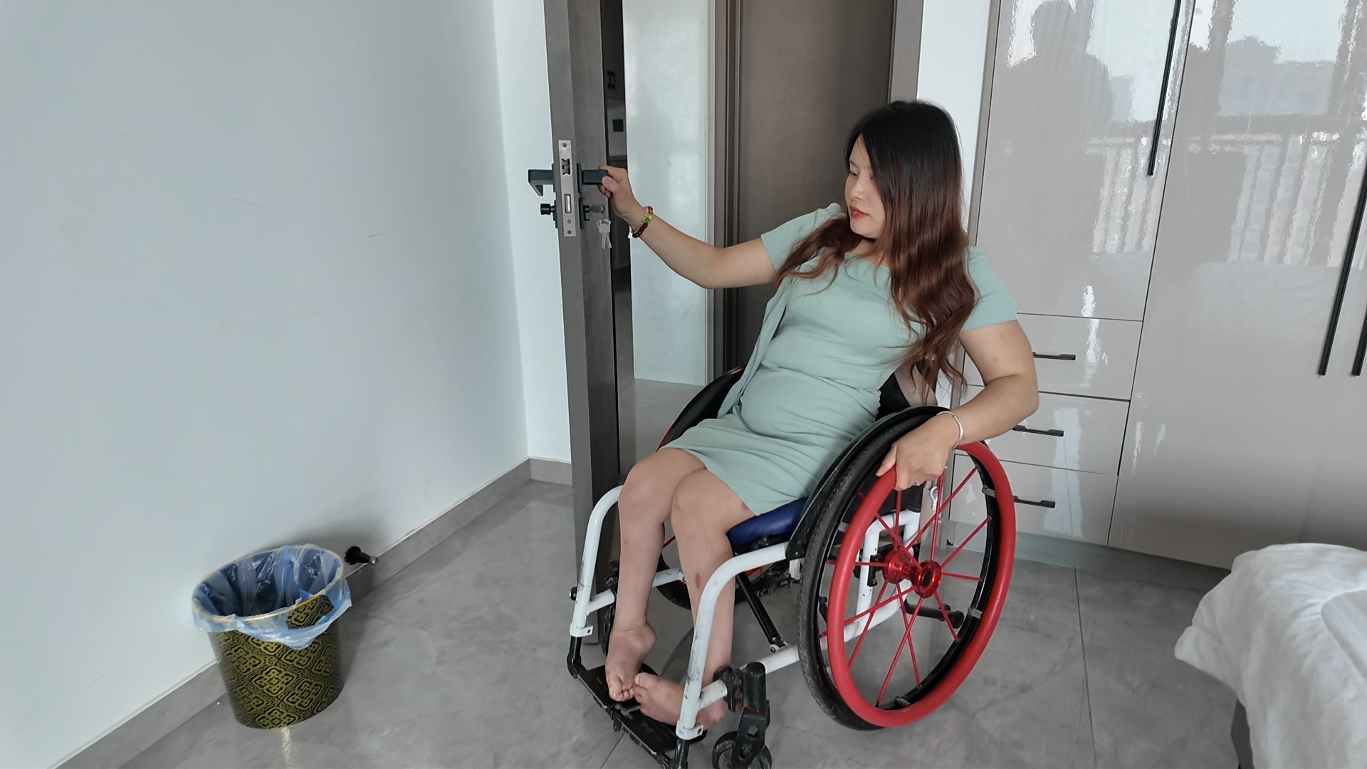 Shera: Paraplegic Girl tries on black strappy high heels at home.
