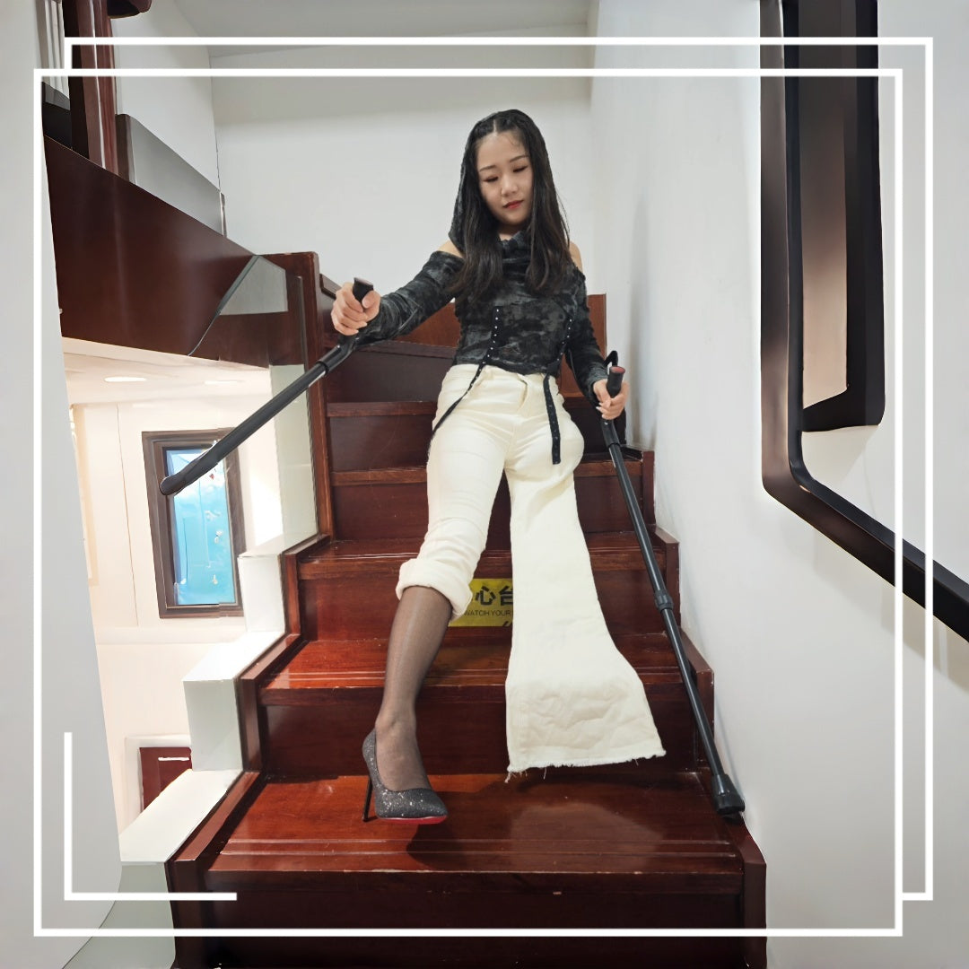 Naomi Sak, an amputee girl, is sitting on the stairs wearing black stockings.