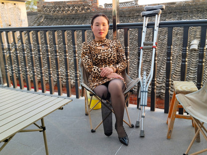 Gigi: Sak Amputee Girl, wearing leopard print stockings and using crutches