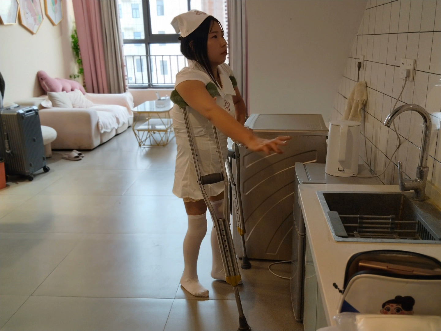 Twlia, a girl with polio - wearing a nurse's uniform and walking with crutches