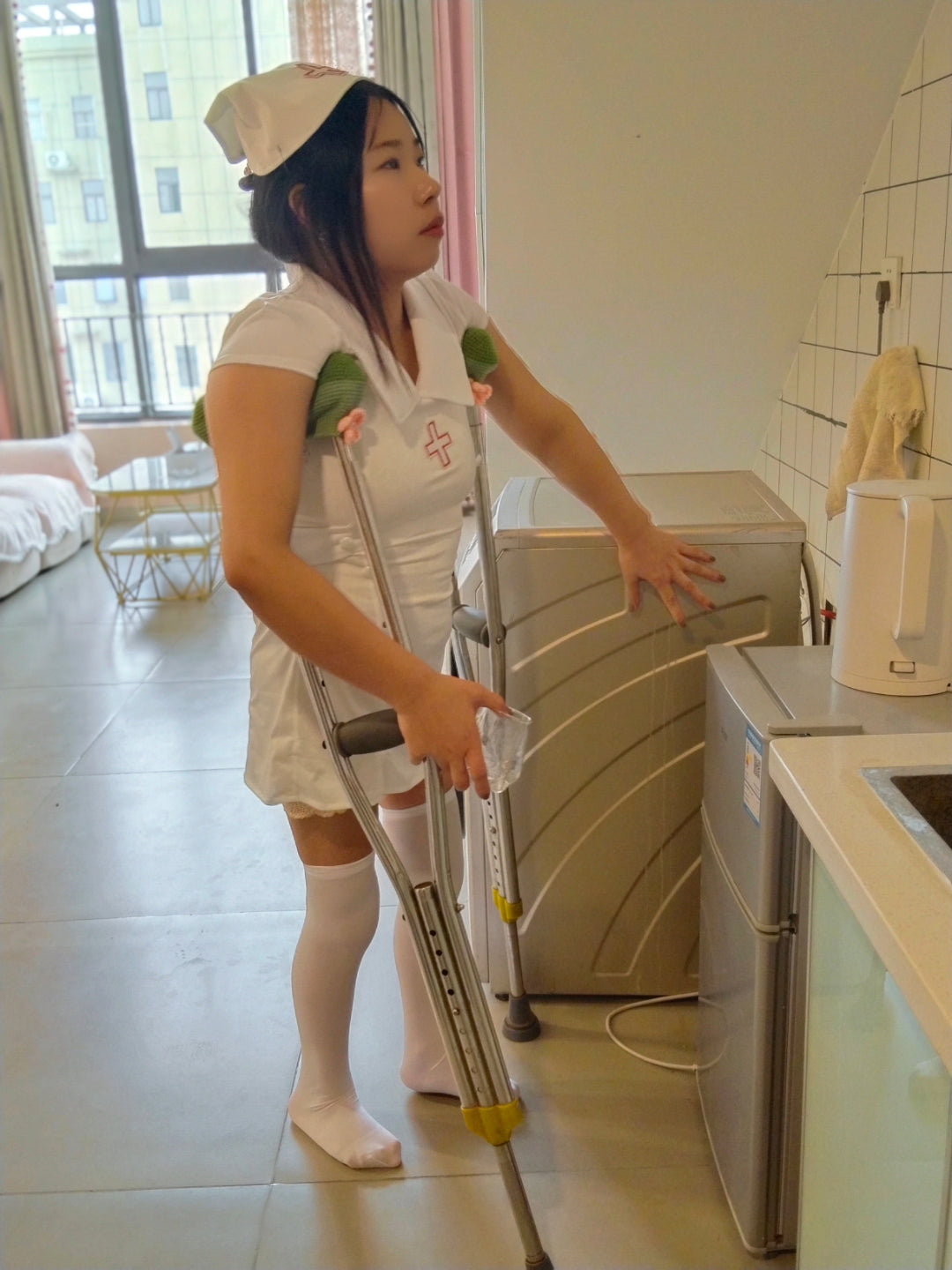 Twlia, a girl with polio - wearing a nurse's uniform and walking with crutches