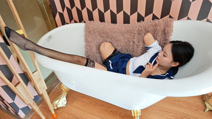 Abby: Ooe Amputee Girl, feeling her prosthetic limb while wearing a Japanese school uniform.