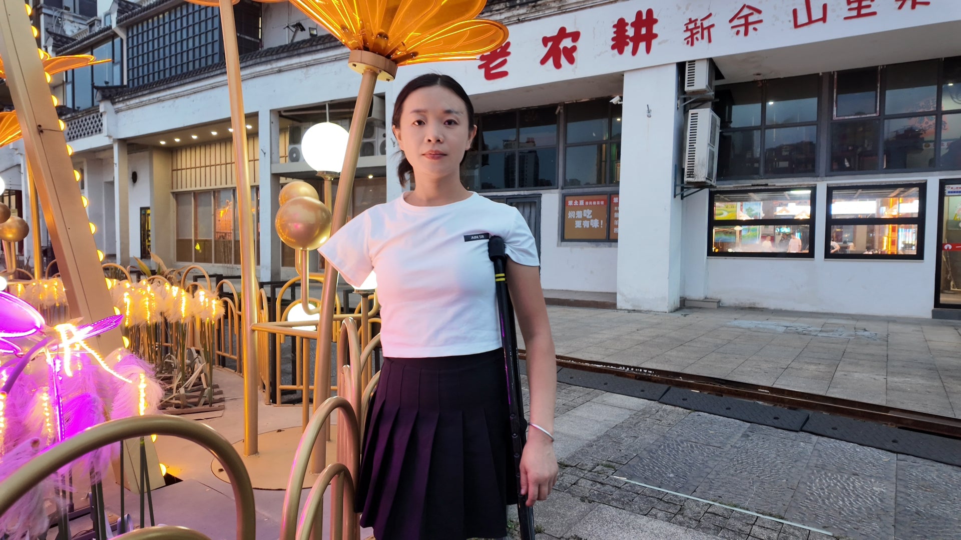 Mila: Ooe, the amputee girl, walking alone by the river with crutches.