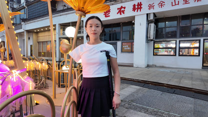 Mila: Ooe, the amputee girl, walking alone by the river with crutches.