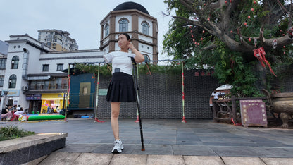 Mila: Ooe, the amputee girl, walking alone by the river with crutches.