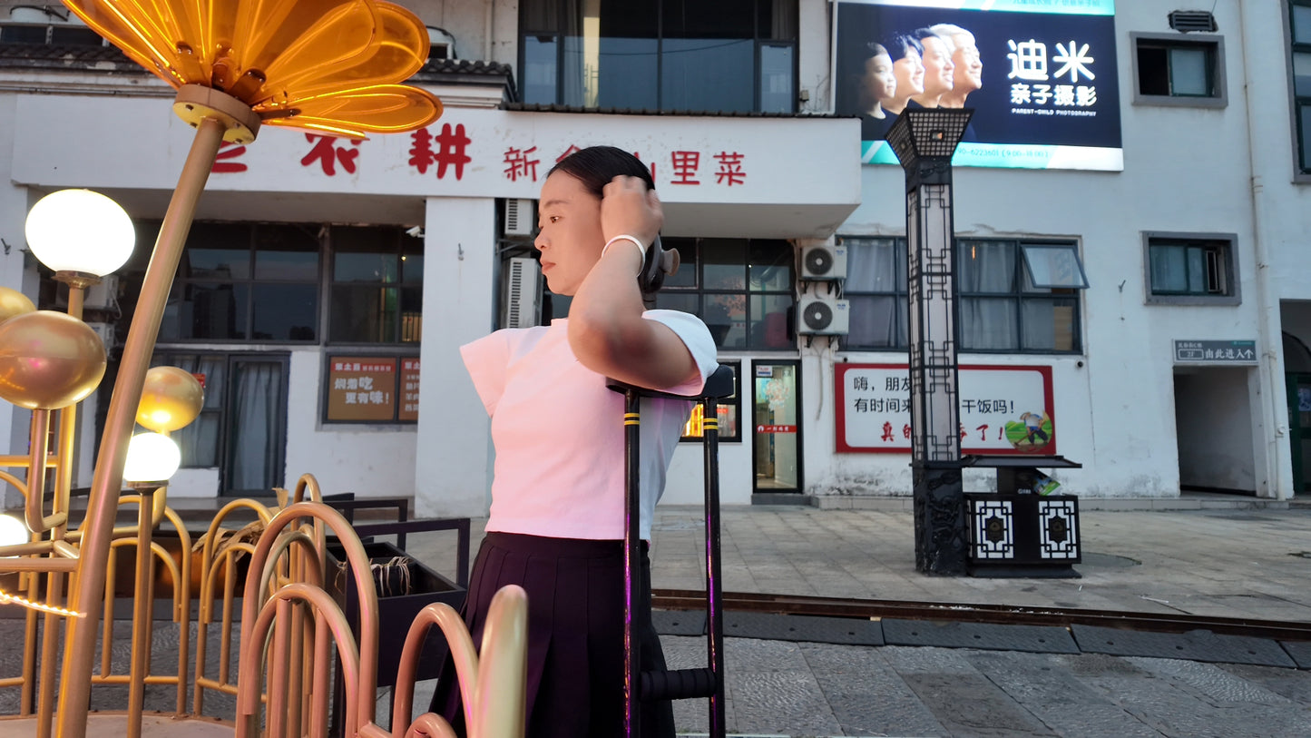Mila: Ooe, the amputee girl, walking alone by the river with crutches.