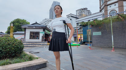 Mila: Ooe, the amputee girl, walking alone by the river with crutches.