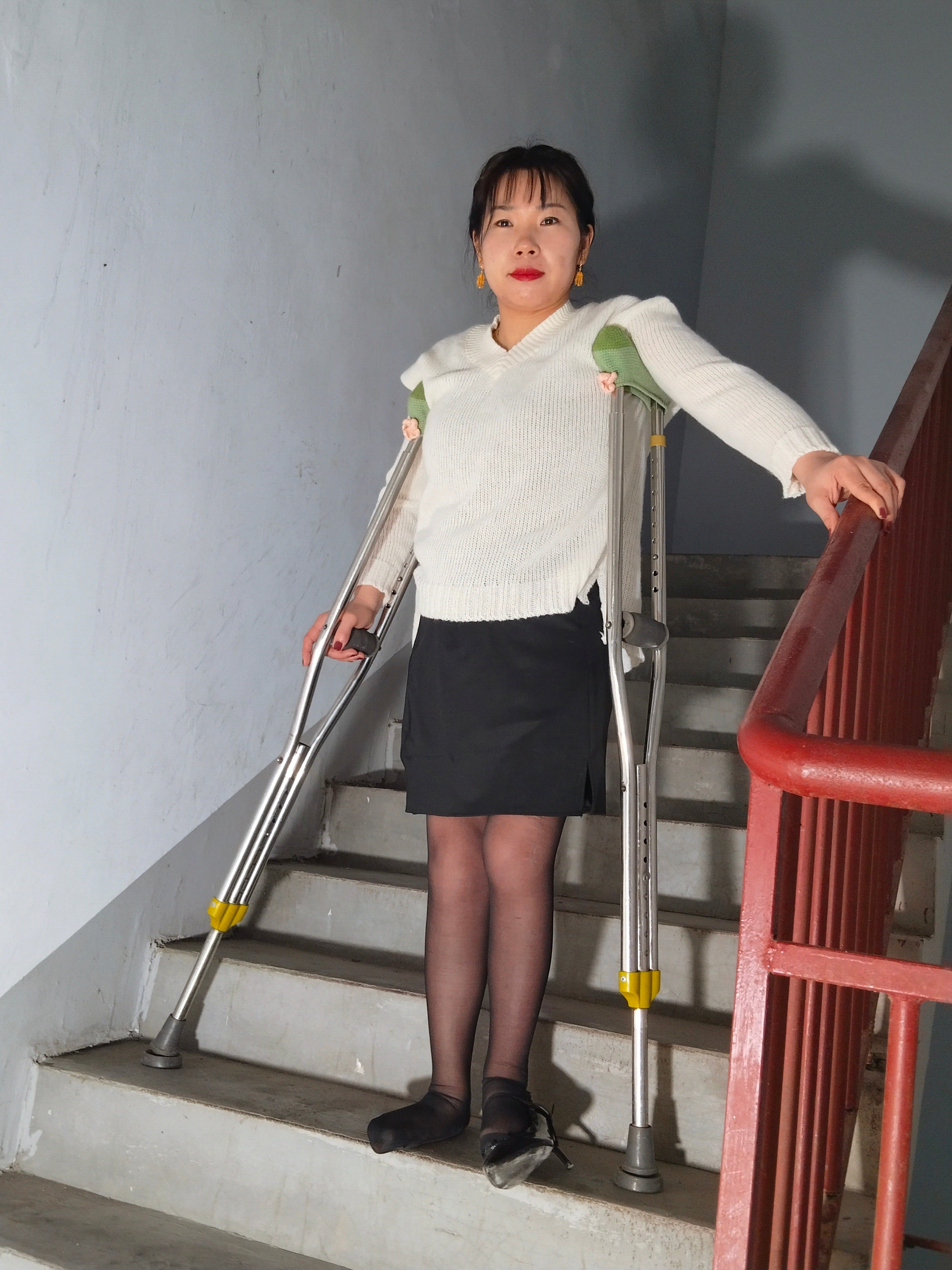 Twlia, a girl with polio - high heels and stockings going up and down stairs