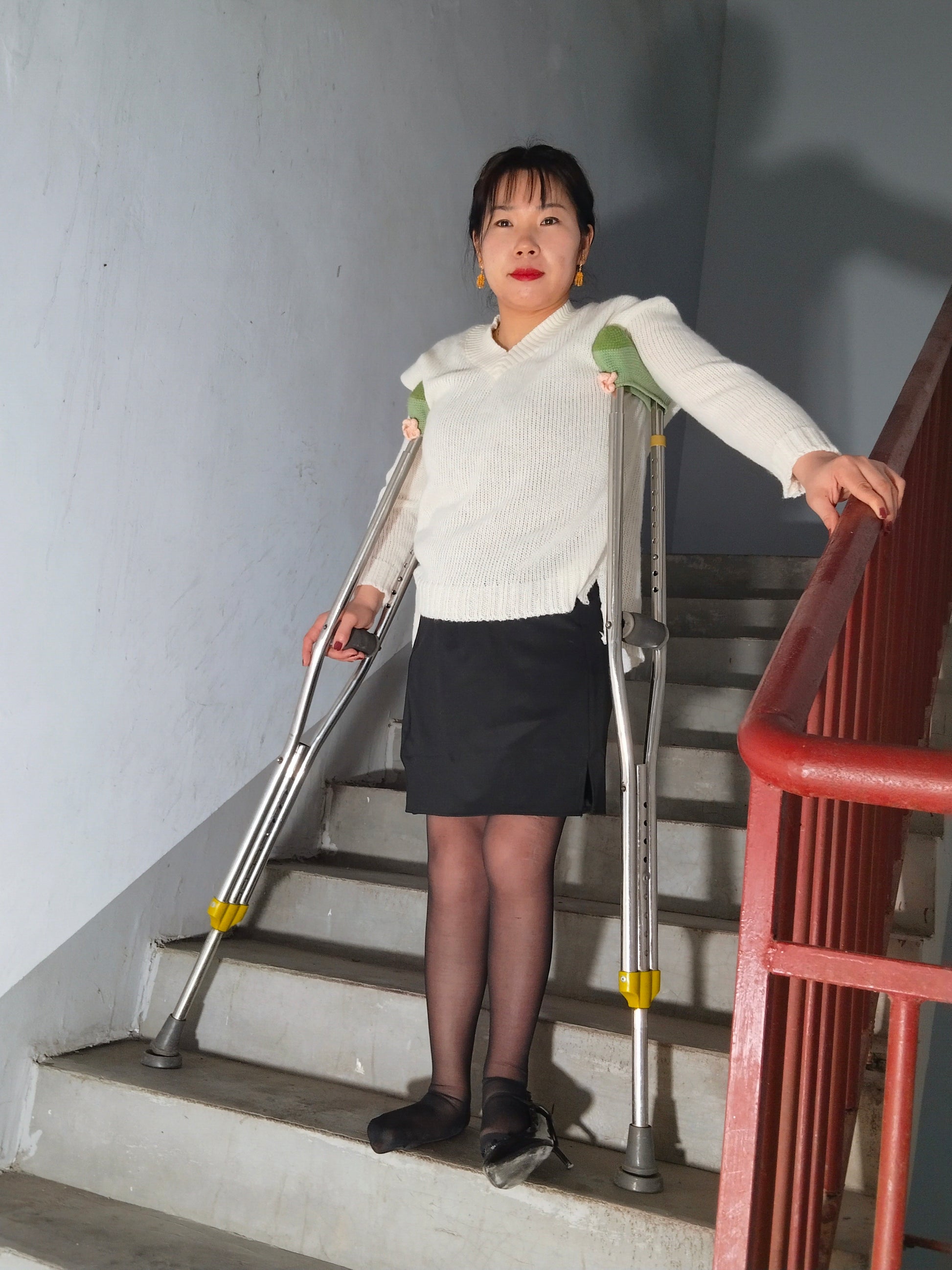 Twlia, a girl with polio - high heels and stockings going up and down stairs