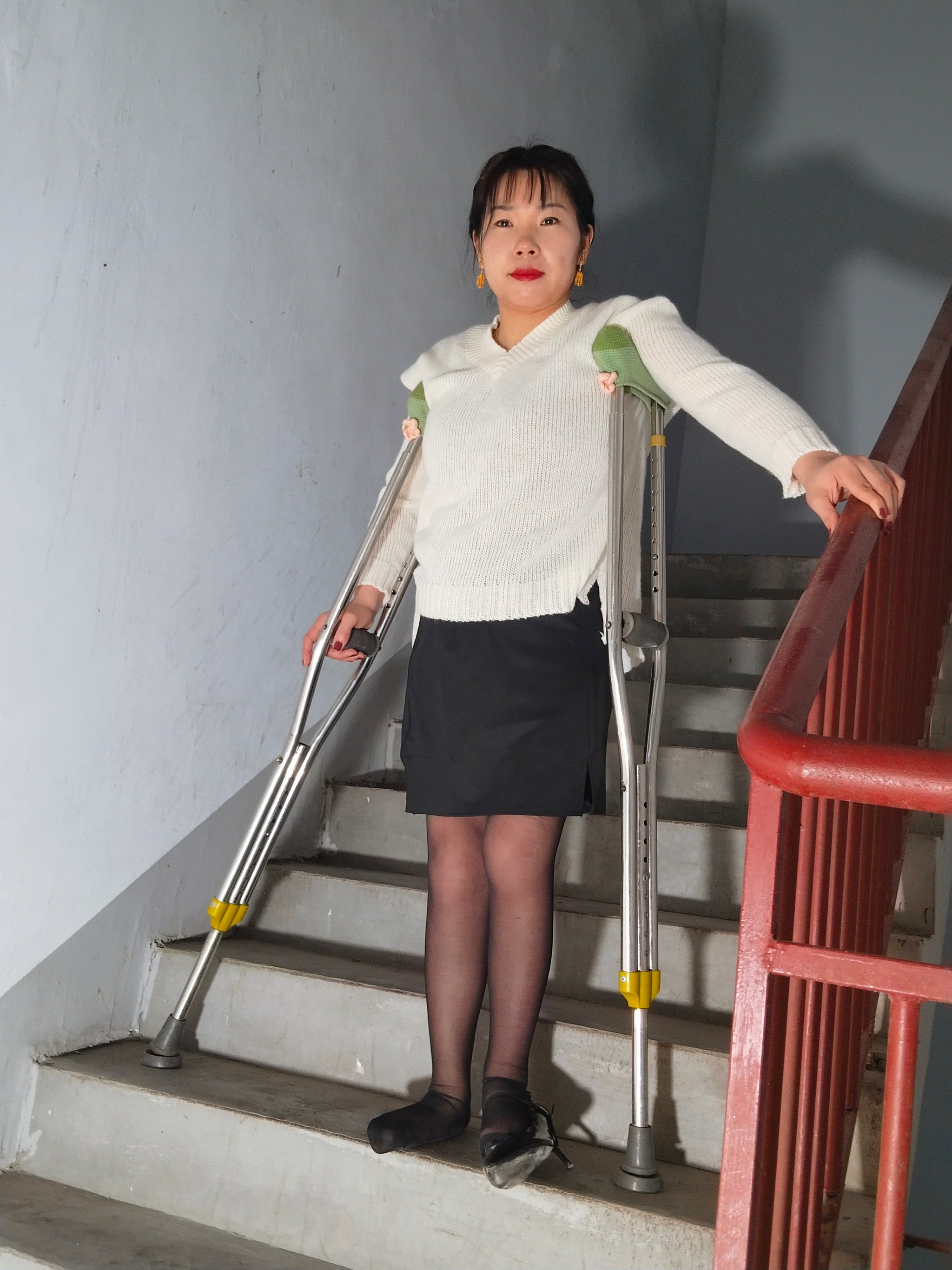 Twlia, a girl with polio - high heels and stockings going up and down stairs