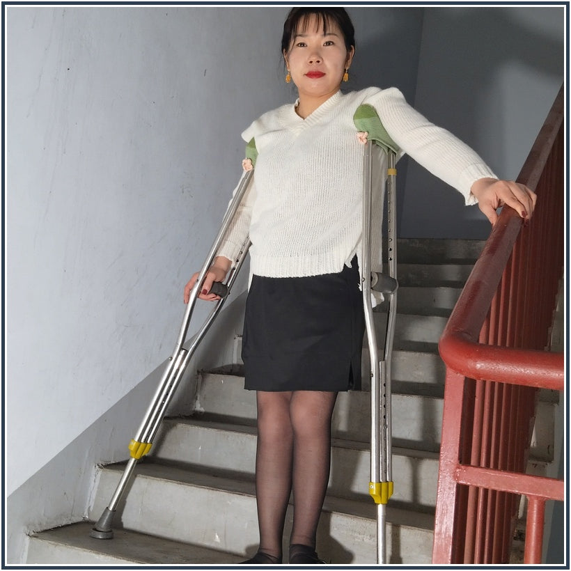 Twlia, a girl with polio - high heels and stockings going up and down stairs